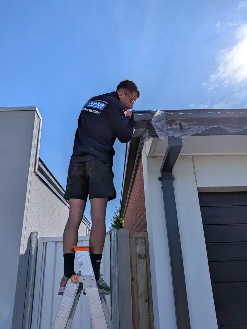 Roof plumber working on gutter in St Kilda